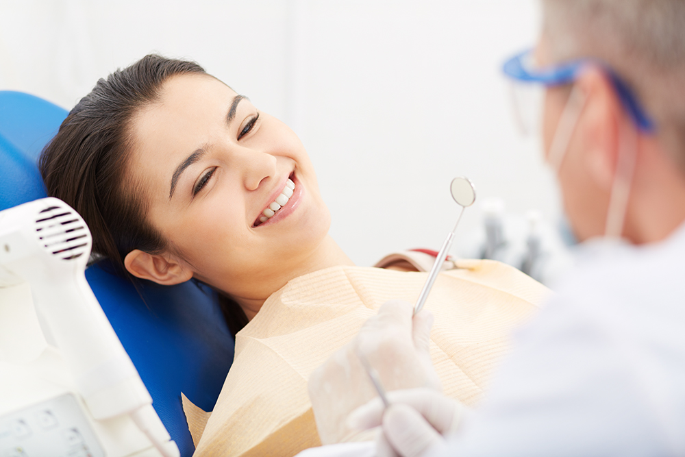 Happy patient Image of smiling patient looking at the dentist